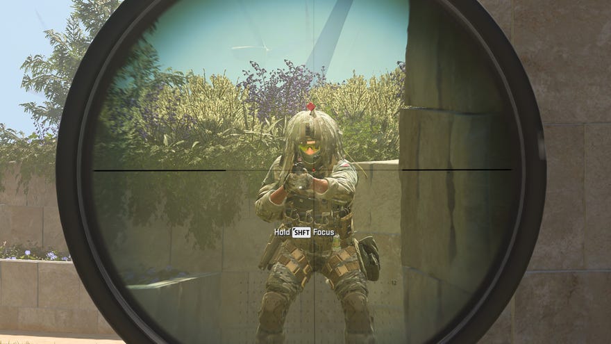 A player's sniper scope zooms in on an enemy soldier in Modern Warfare 3.